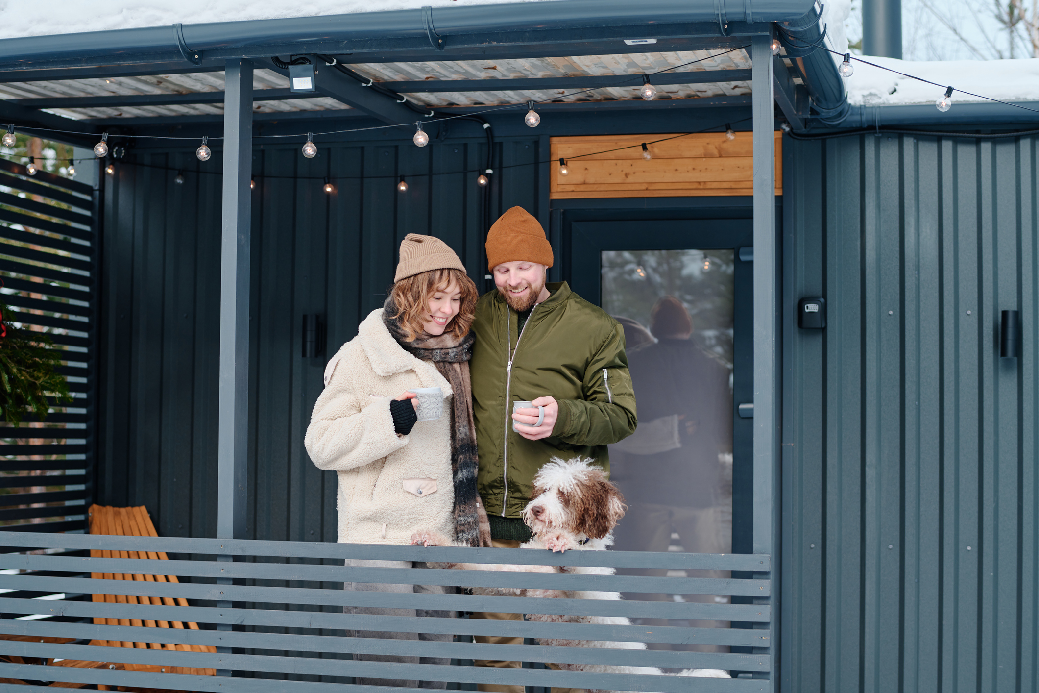 Happy couple enjoying a snowy terrace