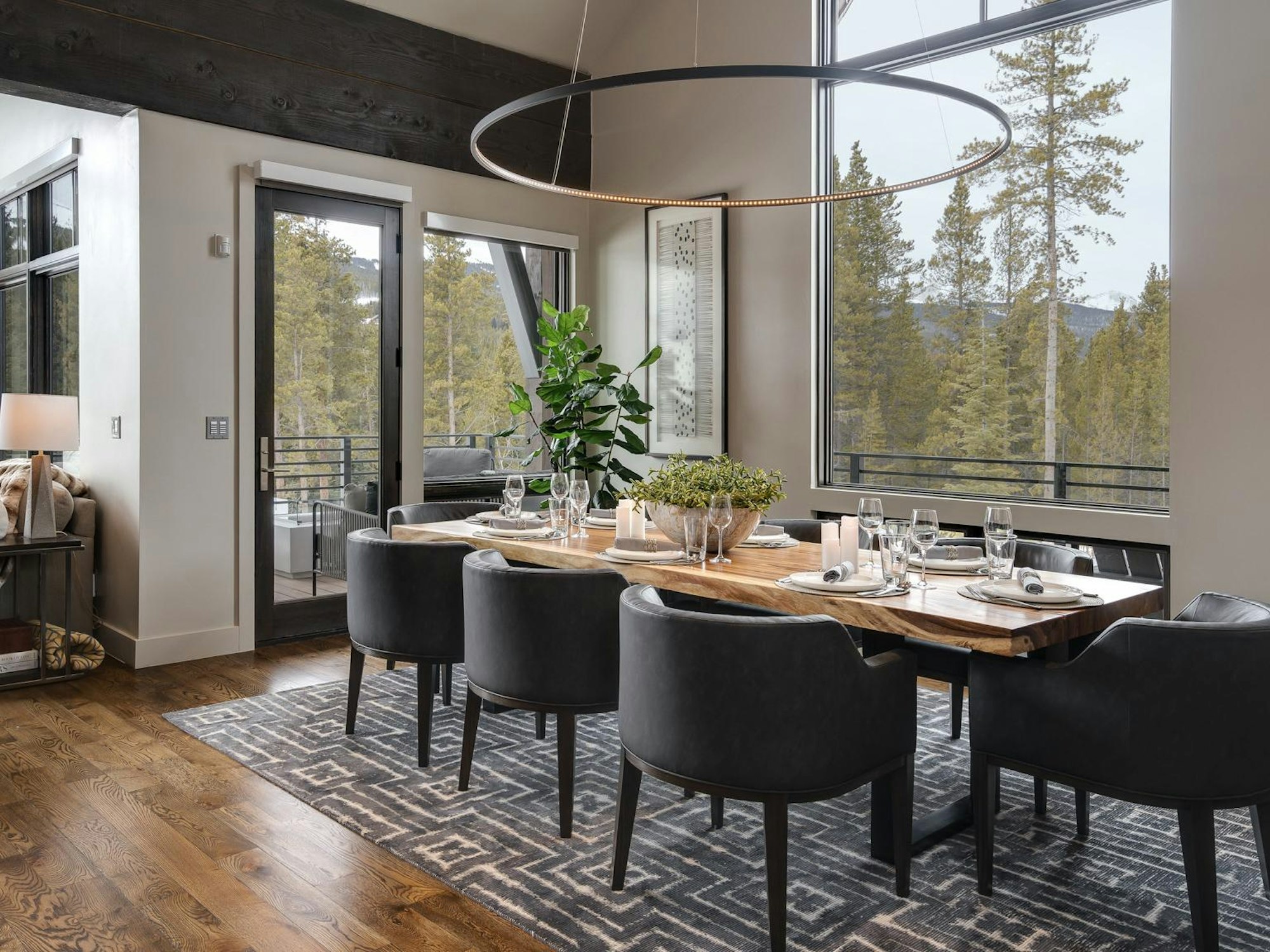 Elegant dining room with modern chandelier and mountain views